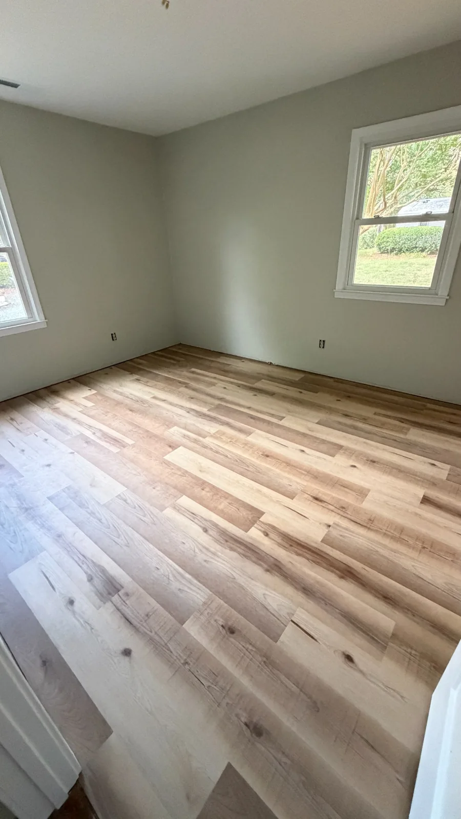 Bedroom with newly installed wood-look plank flooring