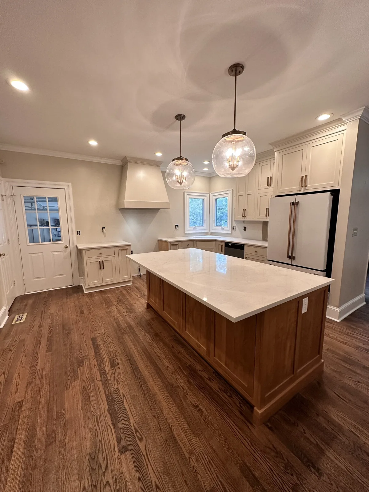 Updated kitchen with white cabinets, countertops and a wood island