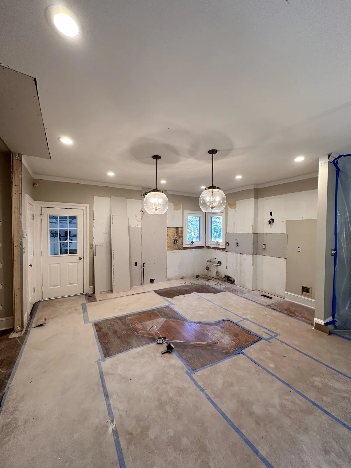 Kitchen with cabinets removed and wall surfaces exposed