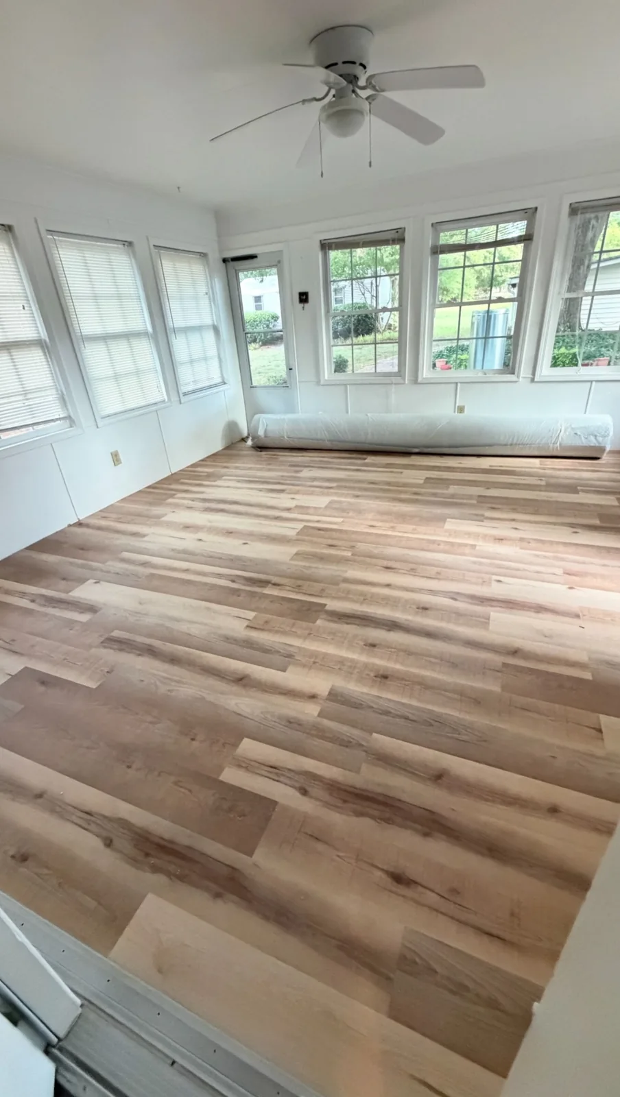 The same room with new wood-look vinyl plank flooring