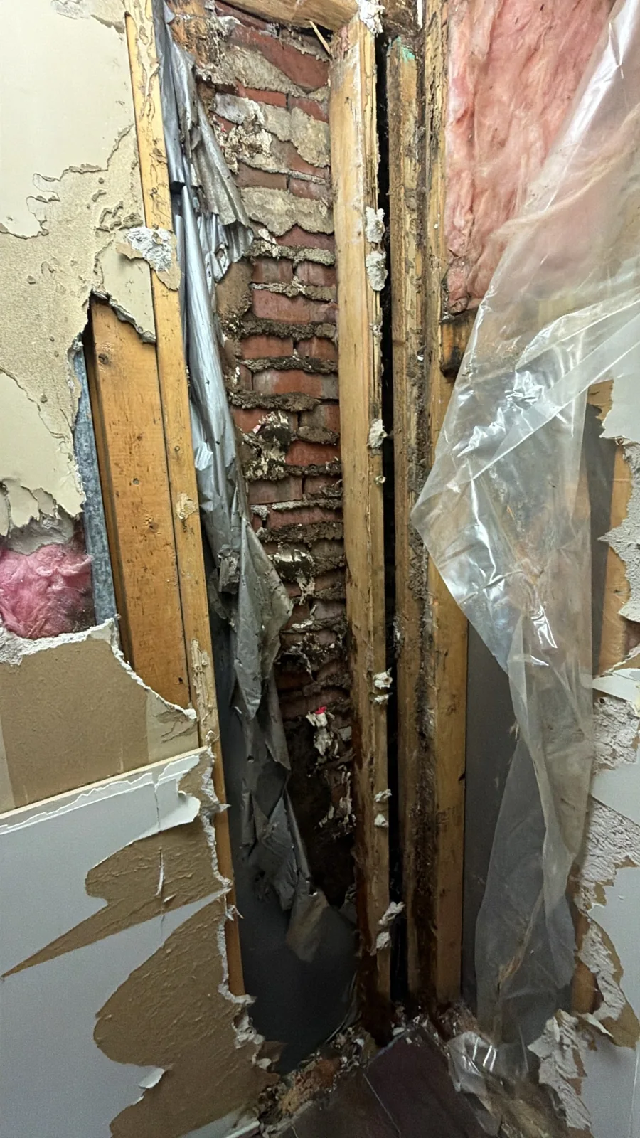 Damaged wall framing exposed after drywall removal